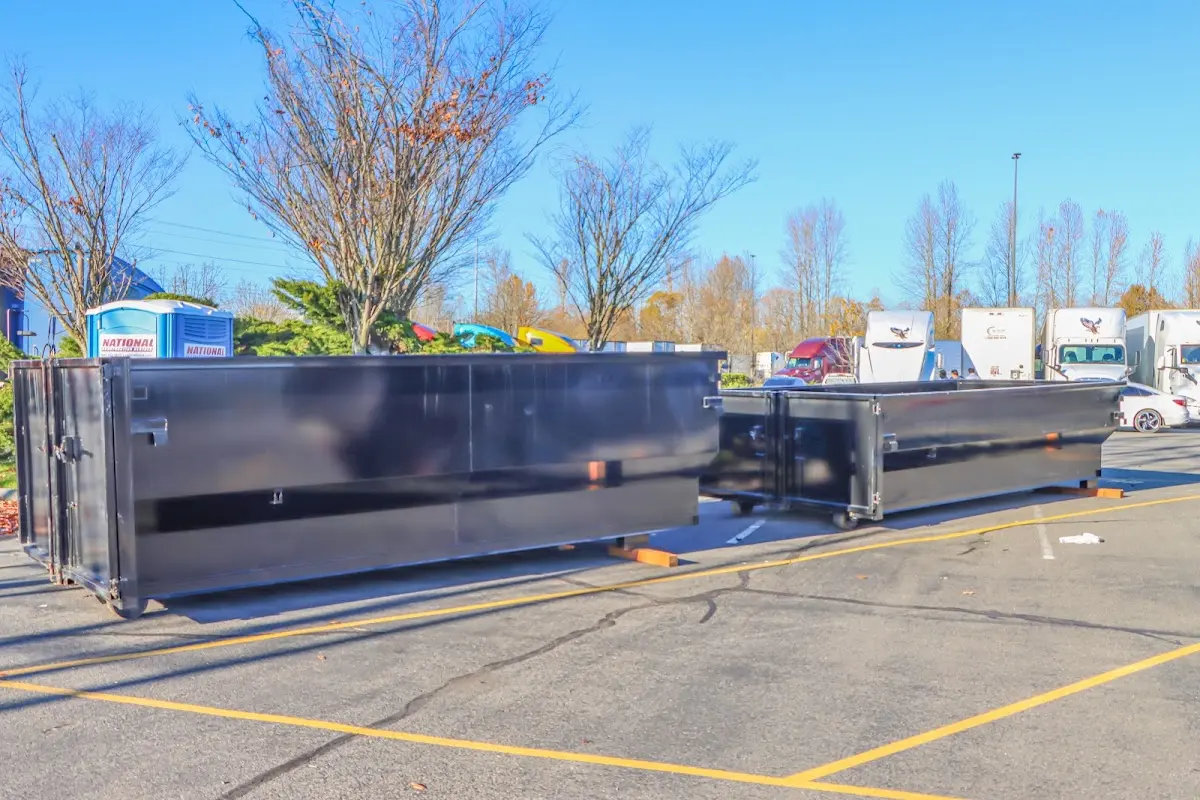 Professional dumpster rental service with roll-off container on residential driveway in New Windsor